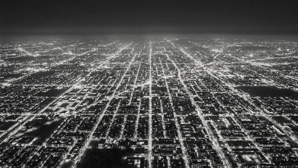Street grid of a large city at night, seen from the air