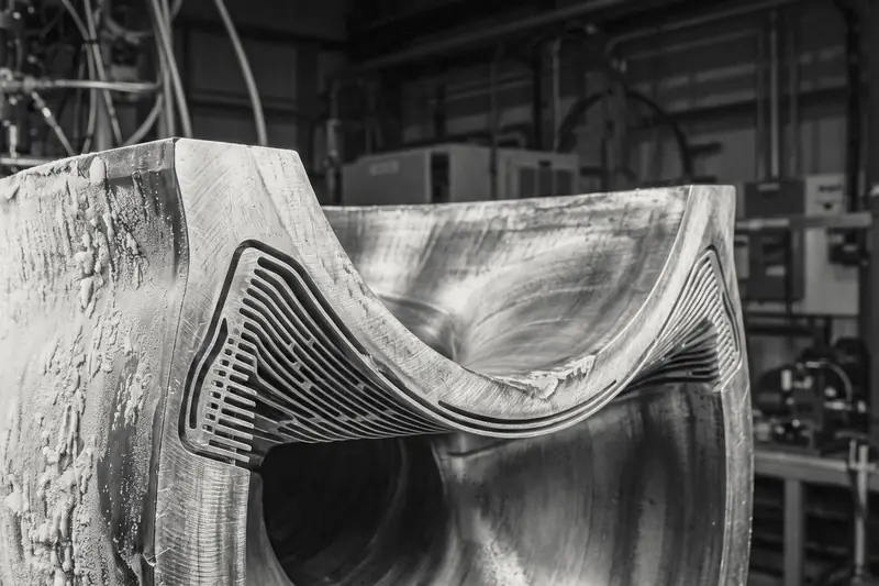 Sectioned rocket nozzle showing its cooling channels, frosted on the outside