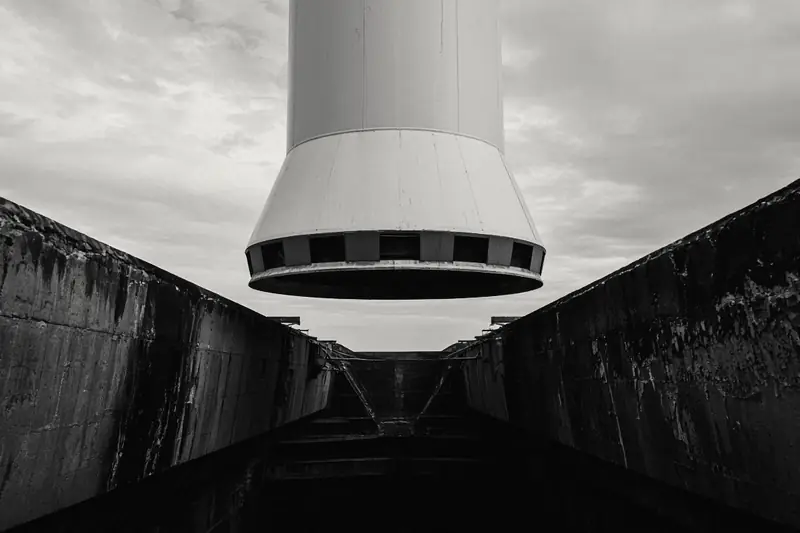 Base of a rocket stage above a scorched concrete flame trench