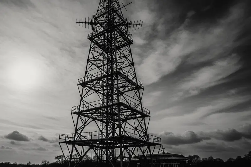 Steel lattice radio mast against a hazy sky